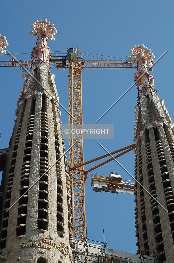 A crane raising between two towers