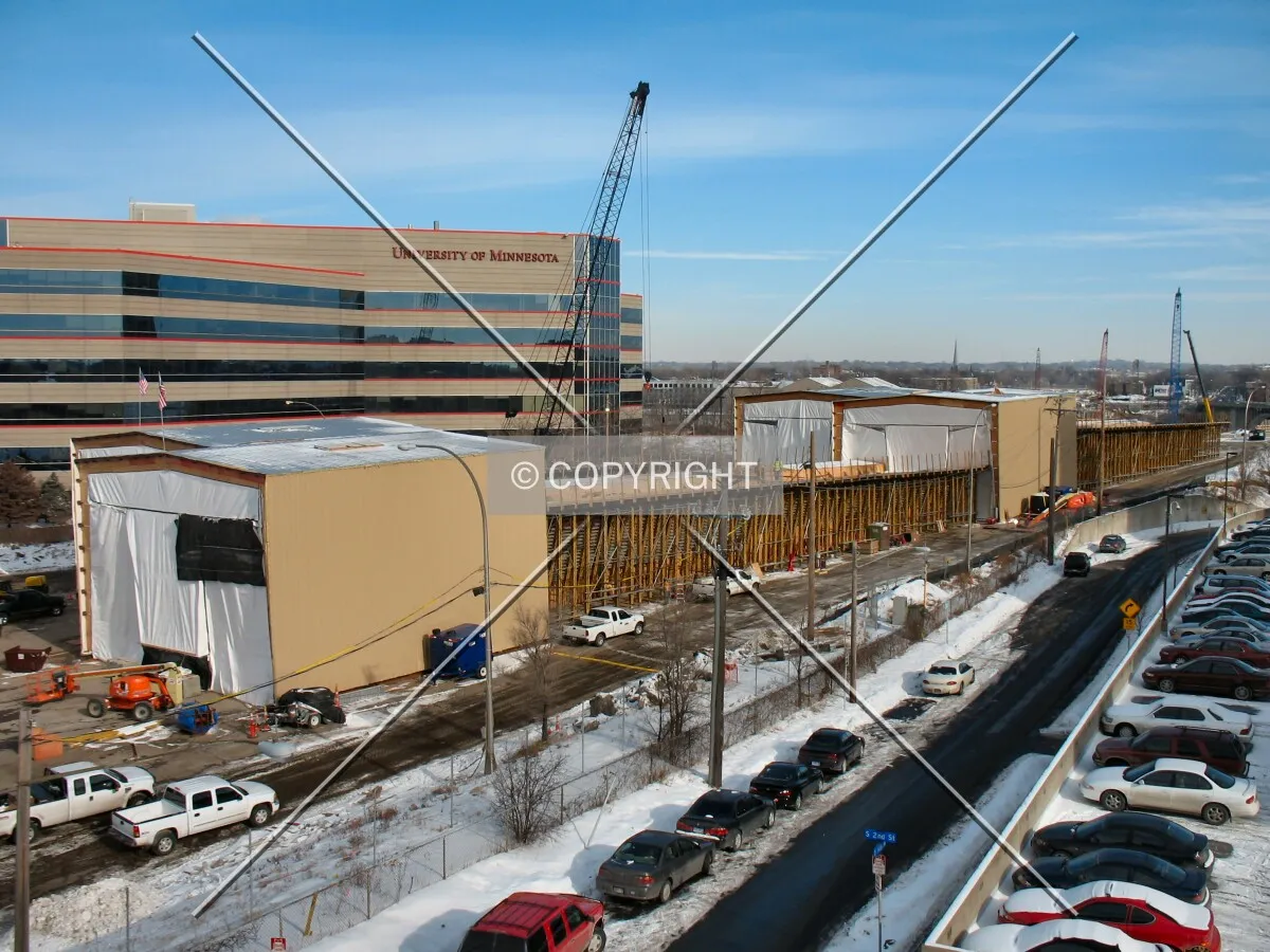 View to the north along the south approach, massive shelters help maintain warmer temperatures when casting bridge segments