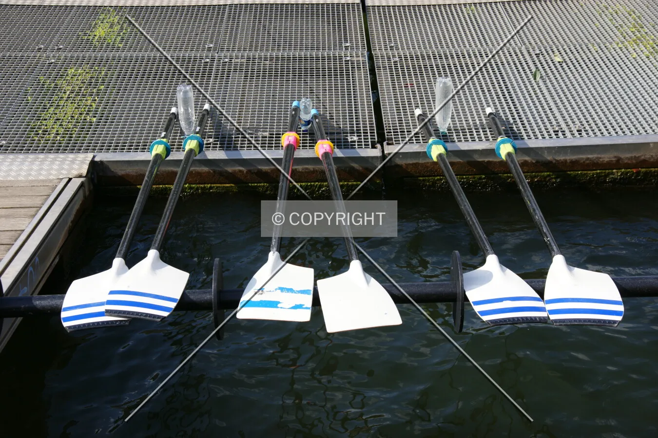 Paddles lying on a pier