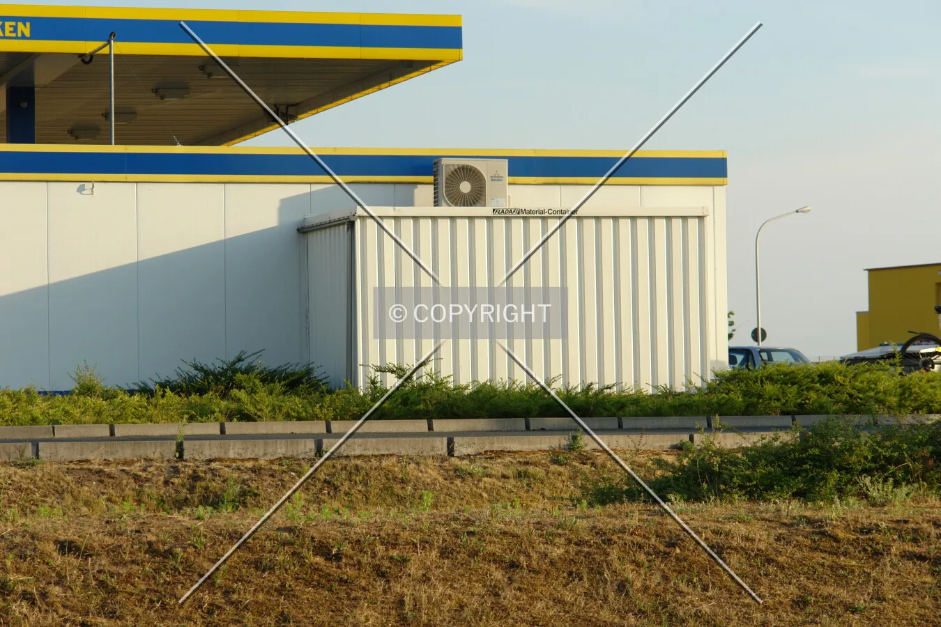 Material and storage container without windows attached to a gas station shop