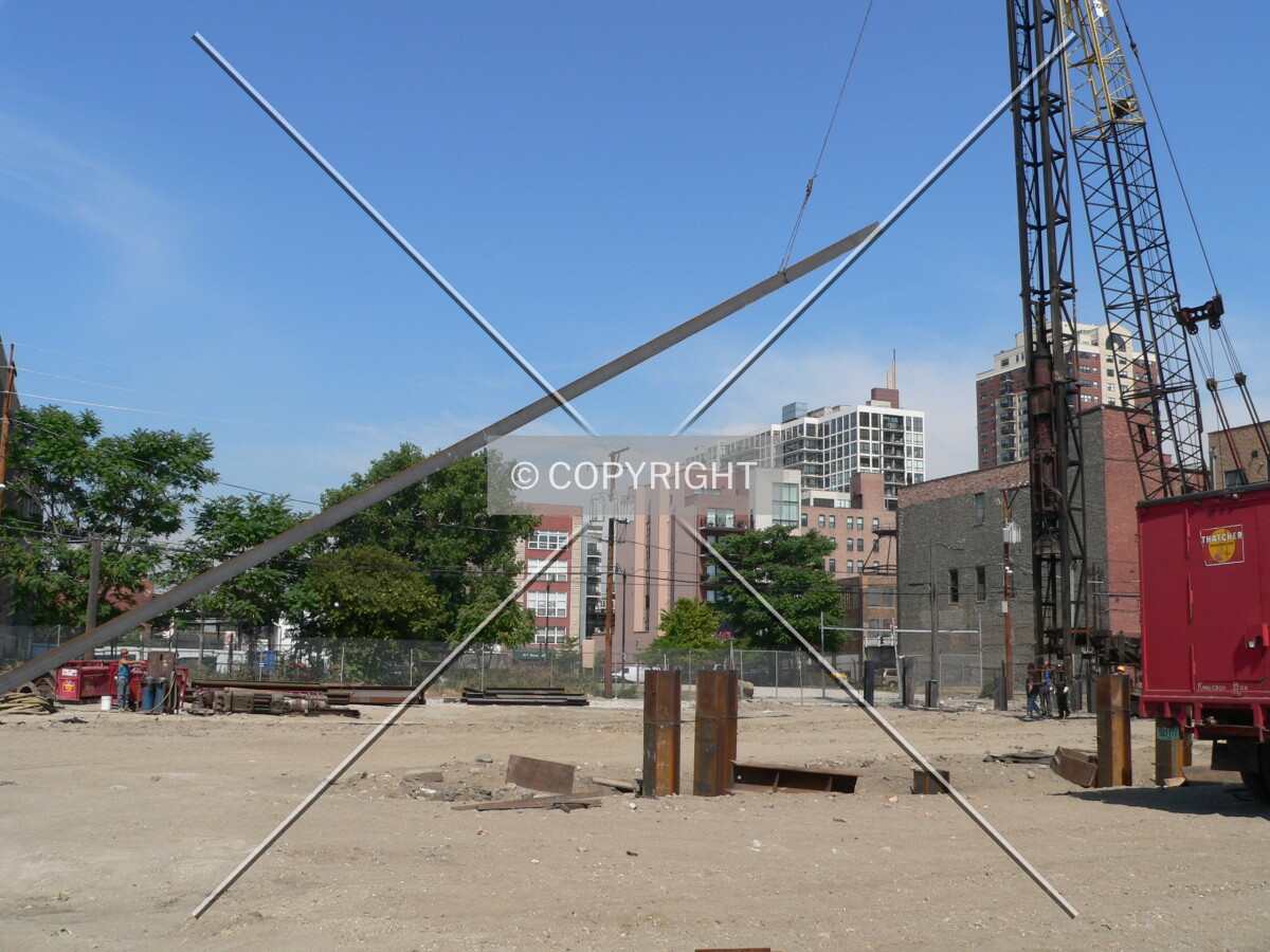 A large pile being lifted into position for installation