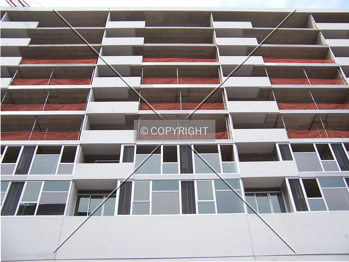 Looking up the south facade from Ontario Street; windows have been installed on the first two residential floors