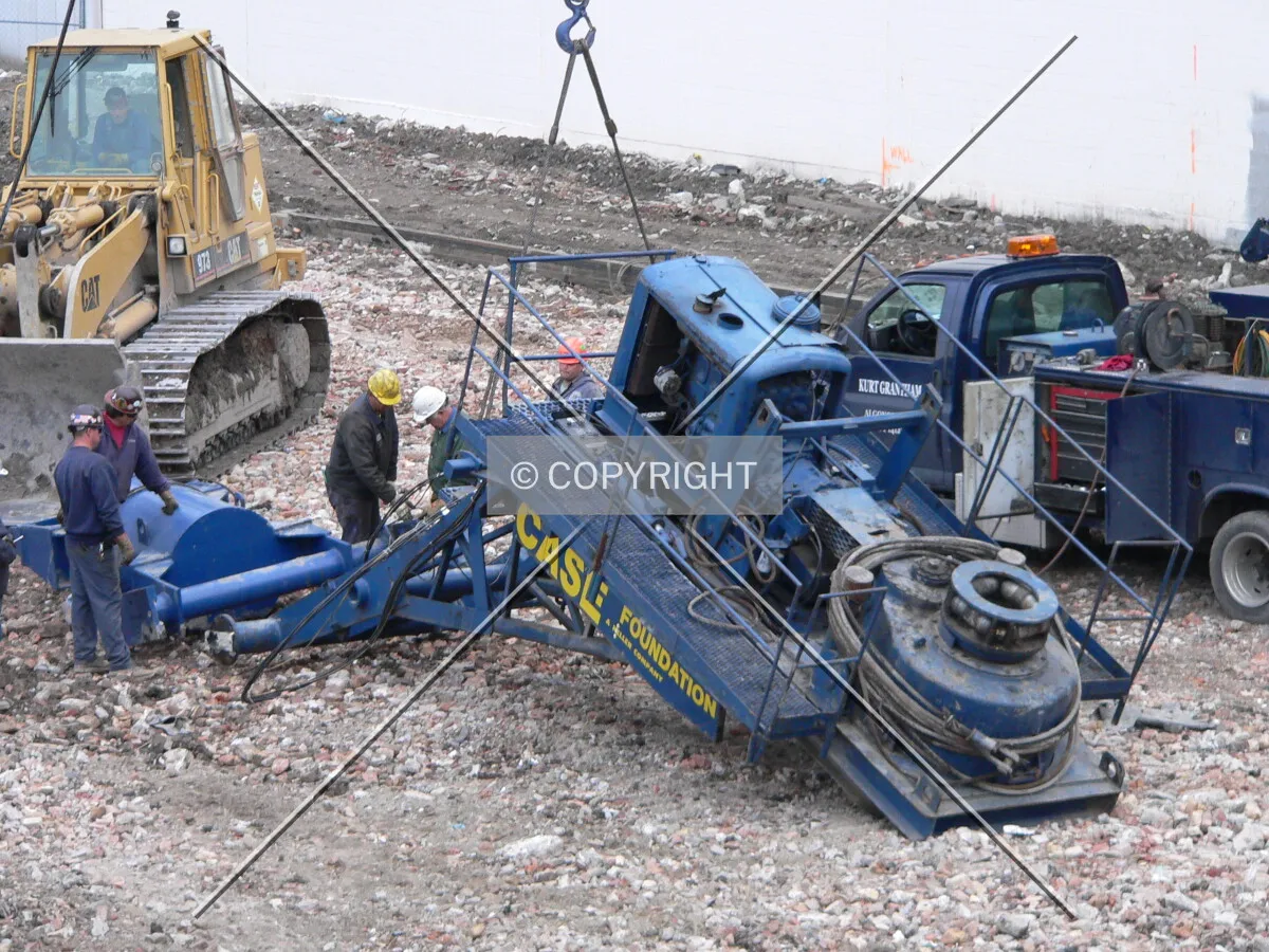 Workers preparing to install the motor for a caisson drilling rig