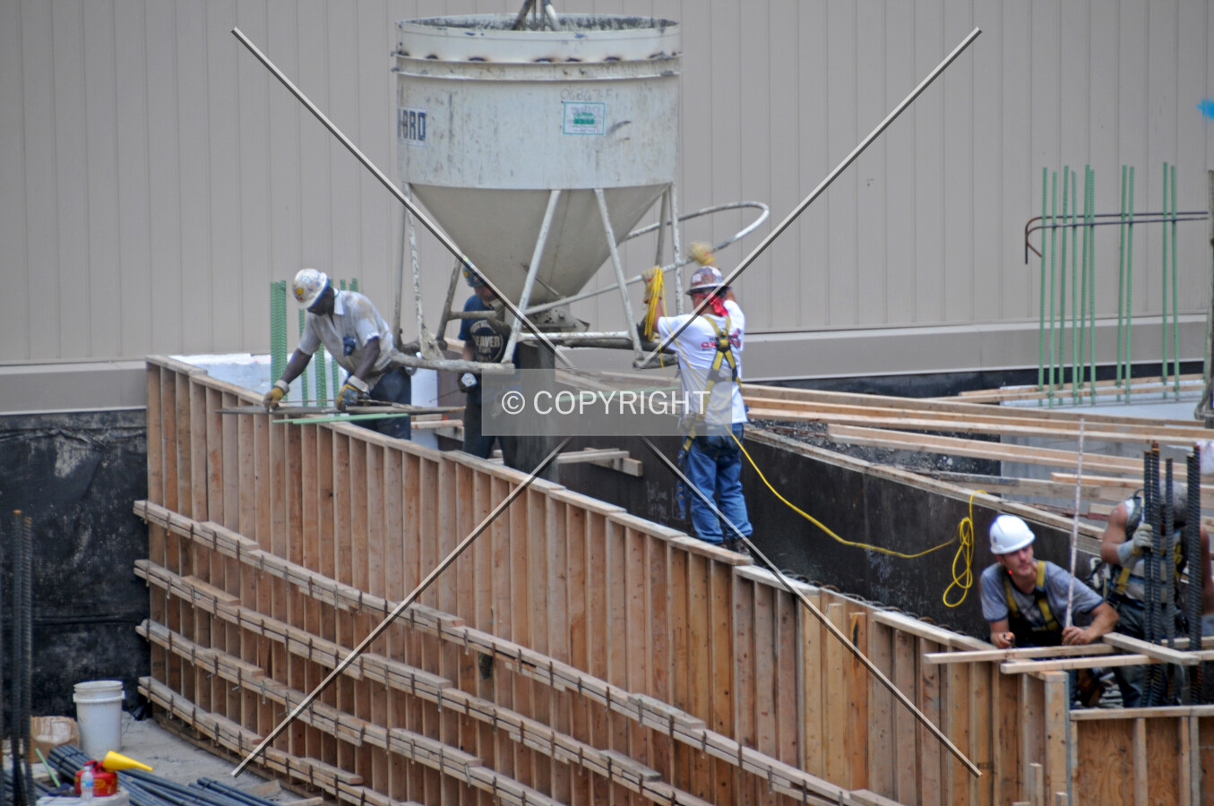 Pouring concrete into a formwork for a foundation grade beam