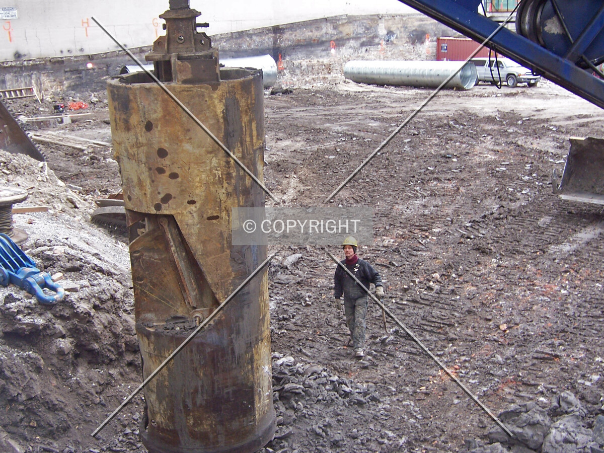 Unloading excavated earth from the caisson bell bucket