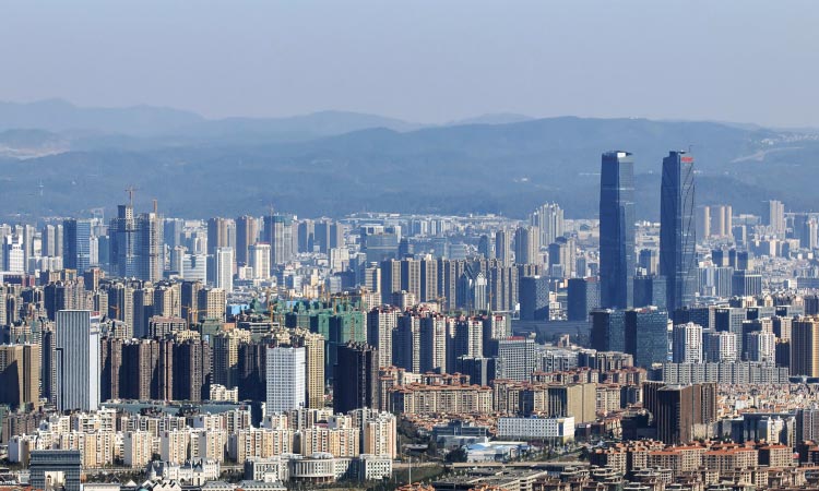 A dense skyline of tall buildings and construction projects